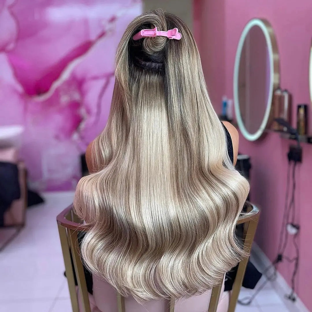Woman with long blonde hair in chair. Hair extension maintenance guide